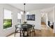Dining room with a modern chandelier and large windows offering wooded views at 7816 Harbor Dr, Raleigh, NC 27615