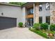Close up of the home's front entrance, showcasing stone and wood accents plus a gray garage door at 7816 Harbor Dr, Raleigh, NC 27615
