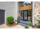 Close up of home's front entrance and door with stone accents and lush landscaping at 7816 Harbor Dr, Raleigh, NC 27615