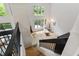 Bright interior view from the staircase with hardwood floors and views of the deck and surrounding woods at 7816 Harbor Dr, Raleigh, NC 27615