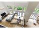 Open floor plan with hardwood floors, exposed brick, high ceilings and large windows with wooded views at 7816 Harbor Dr, Raleigh, NC 27615
