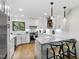 Modern kitchen with white cabinets, stainless steel appliances, marble countertops, and hardwood floors at 7816 Harbor Dr, Raleigh, NC 27615