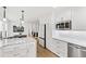 Modern kitchen featuring white cabinets, stainless appliances, marble countertops, and hardwood flooring at 7816 Harbor Dr, Raleigh, NC 27615