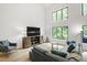 Spacious living room with large windows, stylish furniture, hardwood floors, and plenty of natural light at 7816 Harbor Dr, Raleigh, NC 27615