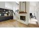 Open floorplan featuring a fireplace, wet bar, built-ins, and hardwood floors throughout the main living area at 7816 Harbor Dr, Raleigh, NC 27615