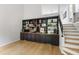 Living room boasting a built-in bookshelf, hardwood floors, and a staircase leading to the upper level at 7816 Harbor Dr, Raleigh, NC 27615