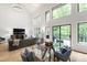 Open-concept living and dining area with high ceilings, hardwood floors, and large windows at 7816 Harbor Dr, Raleigh, NC 27615