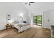 Spacious main bedroom features wood floors, a ceiling fan, vaulted ceilings and a private balcony at 7816 Harbor Dr, Raleigh, NC 27615