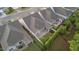 Aerial view of the backyard, highlighting the patio, screened-in porch, manicured yard and privacy fence at 80 Bramble Ln, Clayton, NC 27527