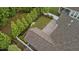 Birds-eye view shows the home with a patio, screened-in porch and lush green yard surrounded by a fence at 80 Bramble Ln, Clayton, NC 27527