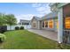 Manicured backyard featuring a screened porch, a patio, and green grass at 80 Bramble Ln, Clayton, NC 27527