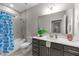 Well-lit bathroom featuring a shower-tub combo and a modern vanity with light marble countertops at 80 Bramble Ln, Clayton, NC 27527