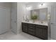 Well-lit bathroom featuring a double vanity with modern fixtures and ample storage at 80 Bramble Ln, Clayton, NC 27527