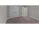 Carpeted bedroom featuring a closet with double doors and a doorway leading to another room at 80 Bramble Ln, Clayton, NC 27527