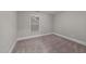 Bright bedroom with carpet, a window with blinds, and base trim around the room at 80 Bramble Ln, Clayton, NC 27527