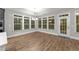 Bright dining area with large windows, hardwood floors, and backyard access at 80 Bramble Ln, Clayton, NC 27527