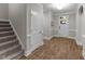 Bright foyer featuring hardwood floors, neutral walls, and an access to the upper level at 80 Bramble Ln, Clayton, NC 27527