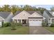 Charming home featuring a two-car garage, well-manicured lawn, and classic architectural details at 80 Bramble Ln, Clayton, NC 27527