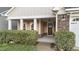 Inviting covered front porch with stone accents and a well-maintained landscape at 80 Bramble Ln, Clayton, NC 27527