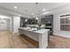 Modern kitchen with a large island, gray cabinets, and stainless steel appliances at 80 Bramble Ln, Clayton, NC 27527