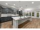Open concept kitchen with gray cabinets, stainless steel appliances, and a large center island at 80 Bramble Ln, Clayton, NC 27527