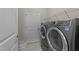 Laundry room with modern washer and dryer and wire shelving for storage space at 80 Bramble Ln, Clayton, NC 27527