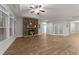 Expansive living room with stone fireplace, hardwood floors, and ample natural light at 80 Bramble Ln, Clayton, NC 27527