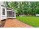 Spacious backyard featuring a screened-in porch, playground, and metal stock tank pool at 8505 Stonegate Dr, Raleigh, NC 27615