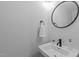 Contemporary half bathroom featuring a modern sink, mirror, and white subway tile backsplash at 8505 Stonegate Dr, Raleigh, NC 27615