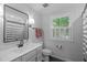 Nicely decorated bathroom with modern fixtures, sleek vanity, and a framed window at 8505 Stonegate Dr, Raleigh, NC 27615