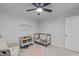 Neutral Bedroom featuring a crib, soft carpet, and a cozy reading nook at 8505 Stonegate Dr, Raleigh, NC 27615