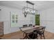 Elegant dining room featuring hardwood floors, wainscoting, and modern light fixture at 8505 Stonegate Dr, Raleigh, NC 27615