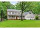 Charming two-story home with a welcoming front porch, attached garage, and lush green lawn at 8505 Stonegate Dr, Raleigh, NC 27615