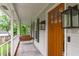 Cozy front porch features a classic porch swing and a beautifully stained wood front door at 8505 Stonegate Dr, Raleigh, NC 27615