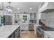 Modern kitchen featuring white cabinets, stainless steel appliances, and stylish marble backsplash at 8505 Stonegate Dr, Raleigh, NC 27615