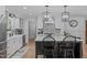 Open kitchen featuring a large island, stainless steel appliances, and modern light fixtures at 8505 Stonegate Dr, Raleigh, NC 27615