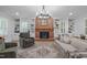 Inviting living room with a brick fireplace, custom built-ins, and ample seating at 8505 Stonegate Dr, Raleigh, NC 27615