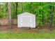 Backyard storage shed with double doors surrounded by mature trees at 8505 Stonegate Dr, Raleigh, NC 27615