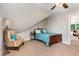 Charming bedroom with sloped ceilings has space for relaxing and sleeping at 8816 Valley Springs Pl, Raleigh, NC 27615