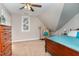 Cozy bedroom with sloped ceilings and a comfortable chair creates a tranquil atmosphere at 8816 Valley Springs Pl, Raleigh, NC 27615