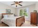 Cozy bedroom with a wood bed and a view from the large window at 8816 Valley Springs Pl, Raleigh, NC 27615