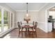 Cozy dining room featuring wainscotting, wood floors, and a large window at 8816 Valley Springs Pl, Raleigh, NC 27615