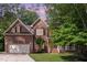 Traditional two-story brick home with an attached two-car garage and mature landscaping at 8816 Valley Springs Pl, Raleigh, NC 27615