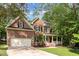 Traditional two-story brick home with an attached two-car garage and mature landscaping at 8816 Valley Springs Pl, Raleigh, NC 27615