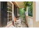 Inviting front porch with rocking chairs and ferns, perfect for relaxing outdoors at 8816 Valley Springs Pl, Raleigh, NC 27615