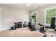 Carpeted gym space with weights and machines is ideal for staying fit at 8816 Valley Springs Pl, Raleigh, NC 27615