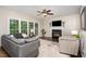 Bright living room with a fireplace, large windows, and stylish furniture at 8816 Valley Springs Pl, Raleigh, NC 27615