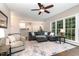 Spacious living room featuring large windows and an open view to the other living spaces at 8816 Valley Springs Pl, Raleigh, NC 27615