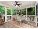 Relaxing screened porch with a ceiling fan, table, chairs, and views of the private backyard at 8816 Valley Springs Pl, Raleigh, NC 27615