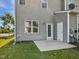 Backyard featuring a patio area, green grass, and home exterior at 8891 Commons Townes Dr, Raleigh, NC 27616